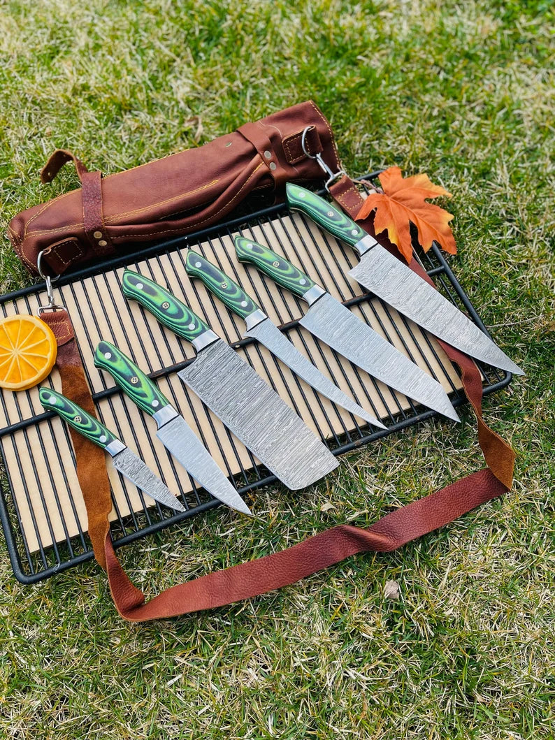 Custom handmade Damascus steel kitchen knife set with G10 handles and steel bolster in leather roll kit