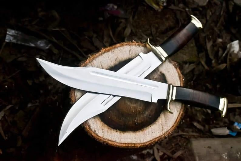 Crocodile Dundee Bowie Knife with brass guard and buffalo horn handle, featuring a leather sheath