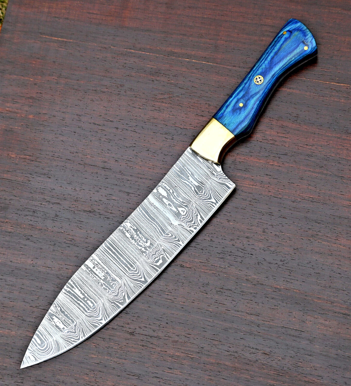 "7-inch Damascus steel chef knife with handcrafted pakkawood handle and brass bolster, featuring a durable, razor-sharp blade