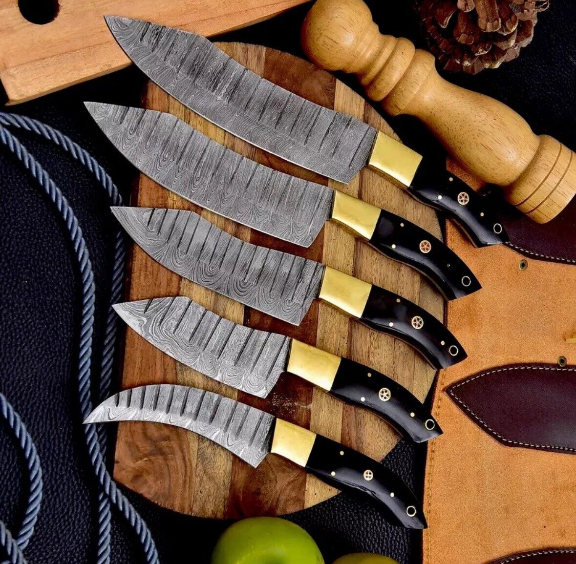 Artisan-crafted Damascus steel knife set featuring beautifully hand-forged blades, buffalo horn handles, and brass bolsters, arranged neatly on a kitchen countertop