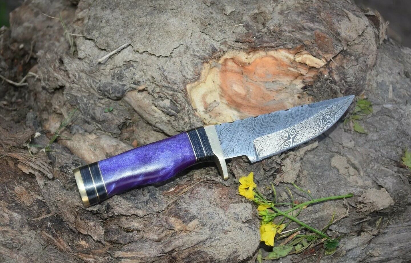 Artisan-made 8-inch hunting knife with a Damascus steel blade and resin handle.