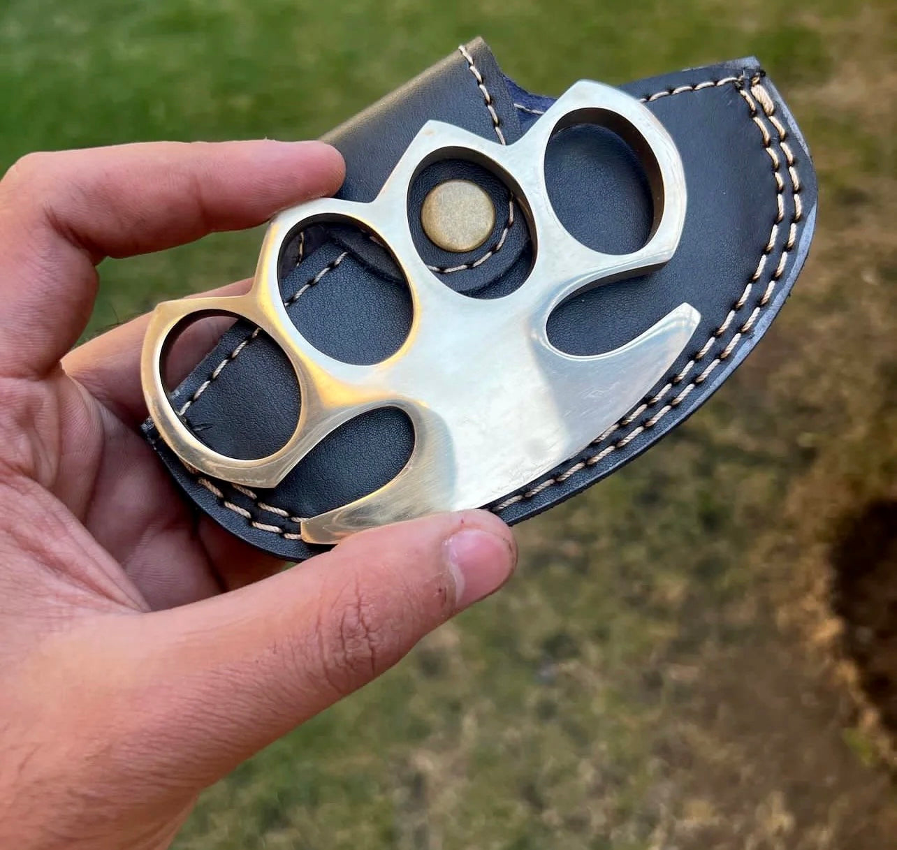 Close-up of custom brass knuckle showcasing robust construction and sleek design