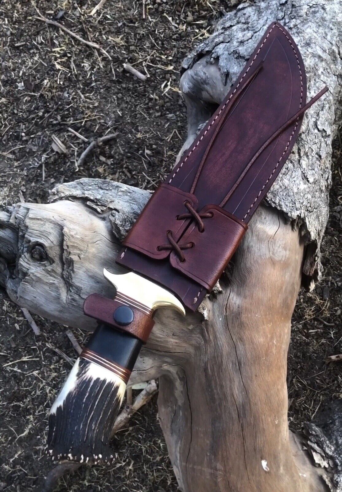 Close-up of the 16-inch J2 steel blade with a brass guard on a handmade hunting knife.