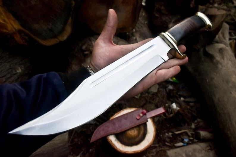 Crocodile Dundee Bowie Knife by Paul Hogan with a 16-inch 440C steel blade, leather and buffalo horn handle, brass guard, and a handmade leather sheath