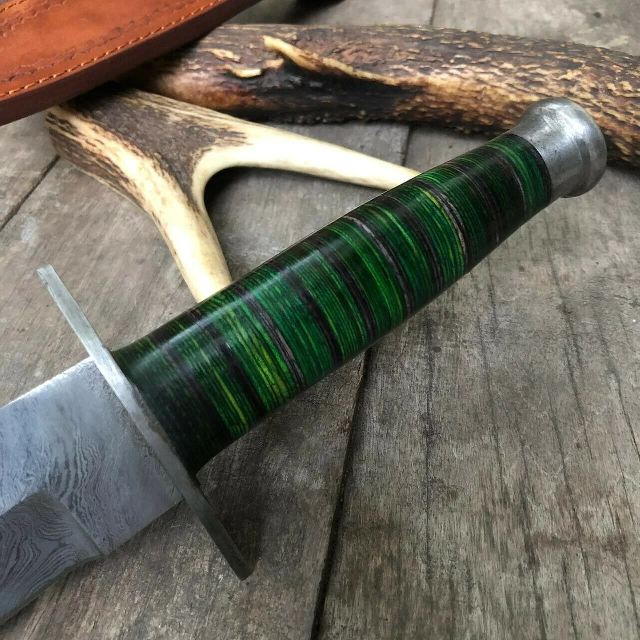 Custom Damascus steel Bowie knife, 12" overall length, featuring a green hardwood handle and Damascus bolster, includes leather sheath
