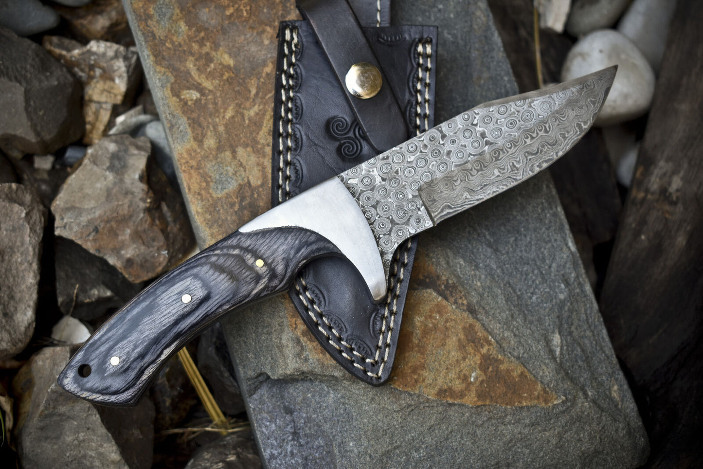Custom Damascus steel hunting knife with pakkawood handle and steel bolster.