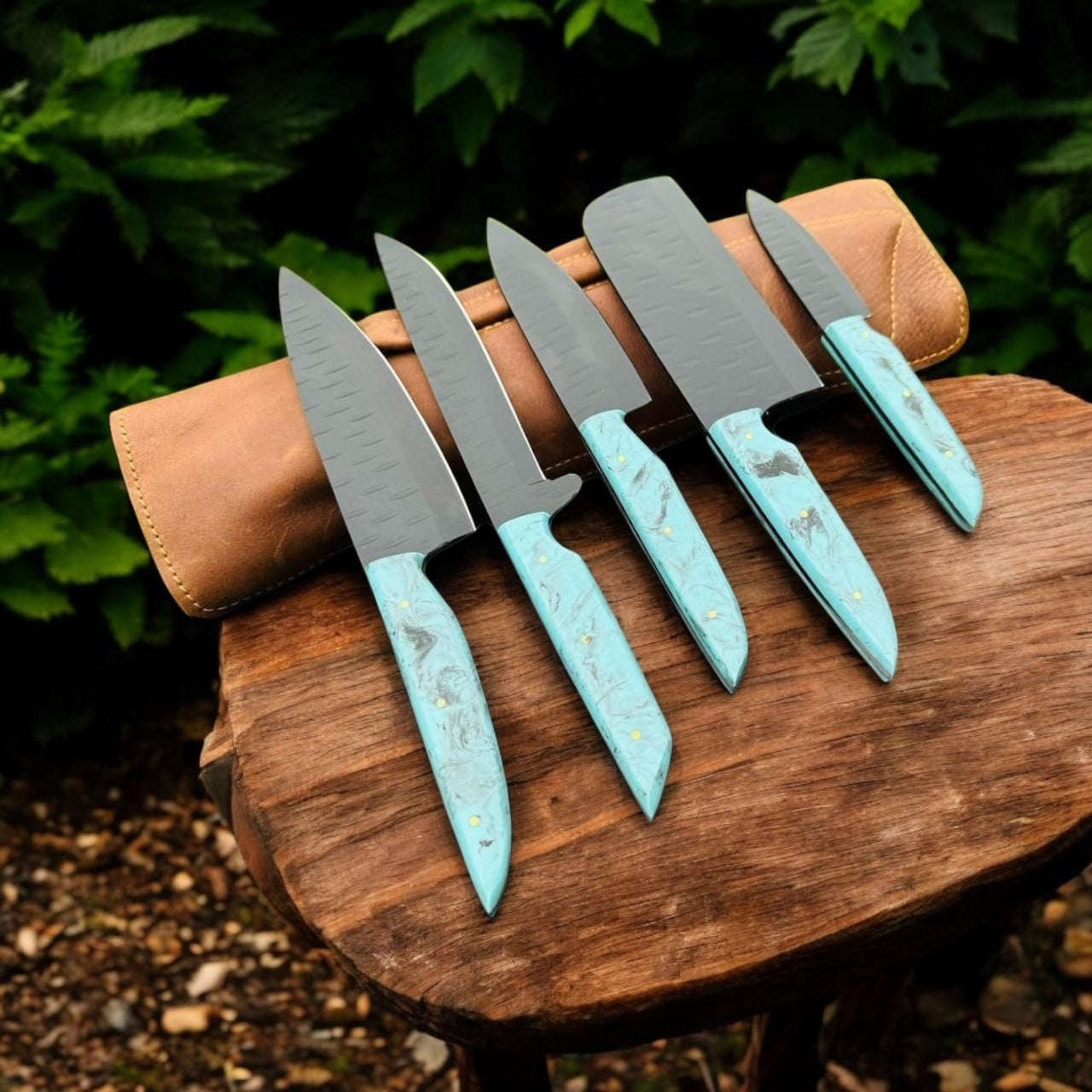 "Custom chef knife set with stainless steel blades and resin handles, stored in a leather case"