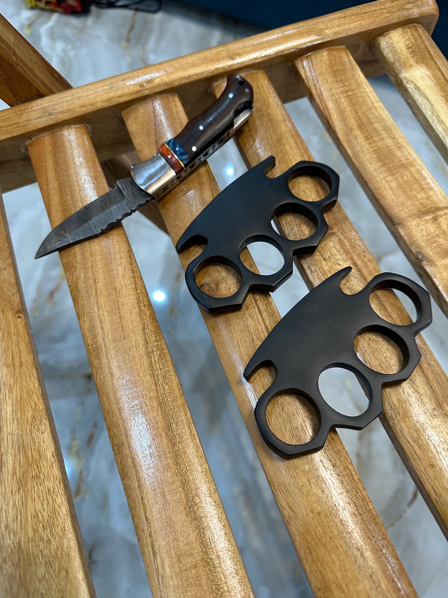 Custom engraved black steel knuckle duster with pocket knife and leather case for self-defense