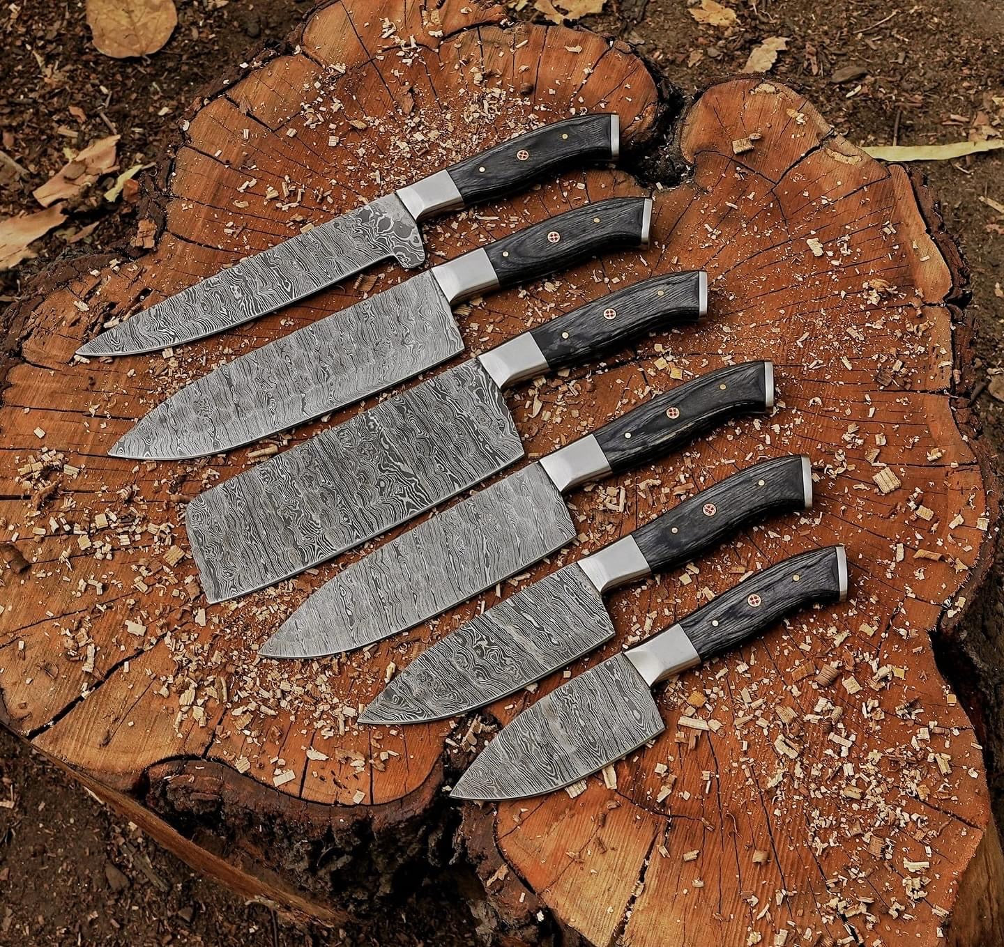 Custom handmade Damascus steel knife set featuring hand-forged blades with pakkawood handles and steel bolsters, ideal for professional and home chefs