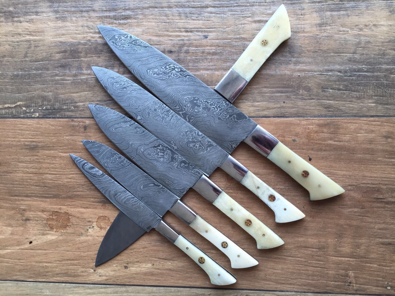Custom handmade Damascus steel knife set with an 8-inch hand-forged blade, camel bone handle, and steel bolster, perfect for chefs and collectors.