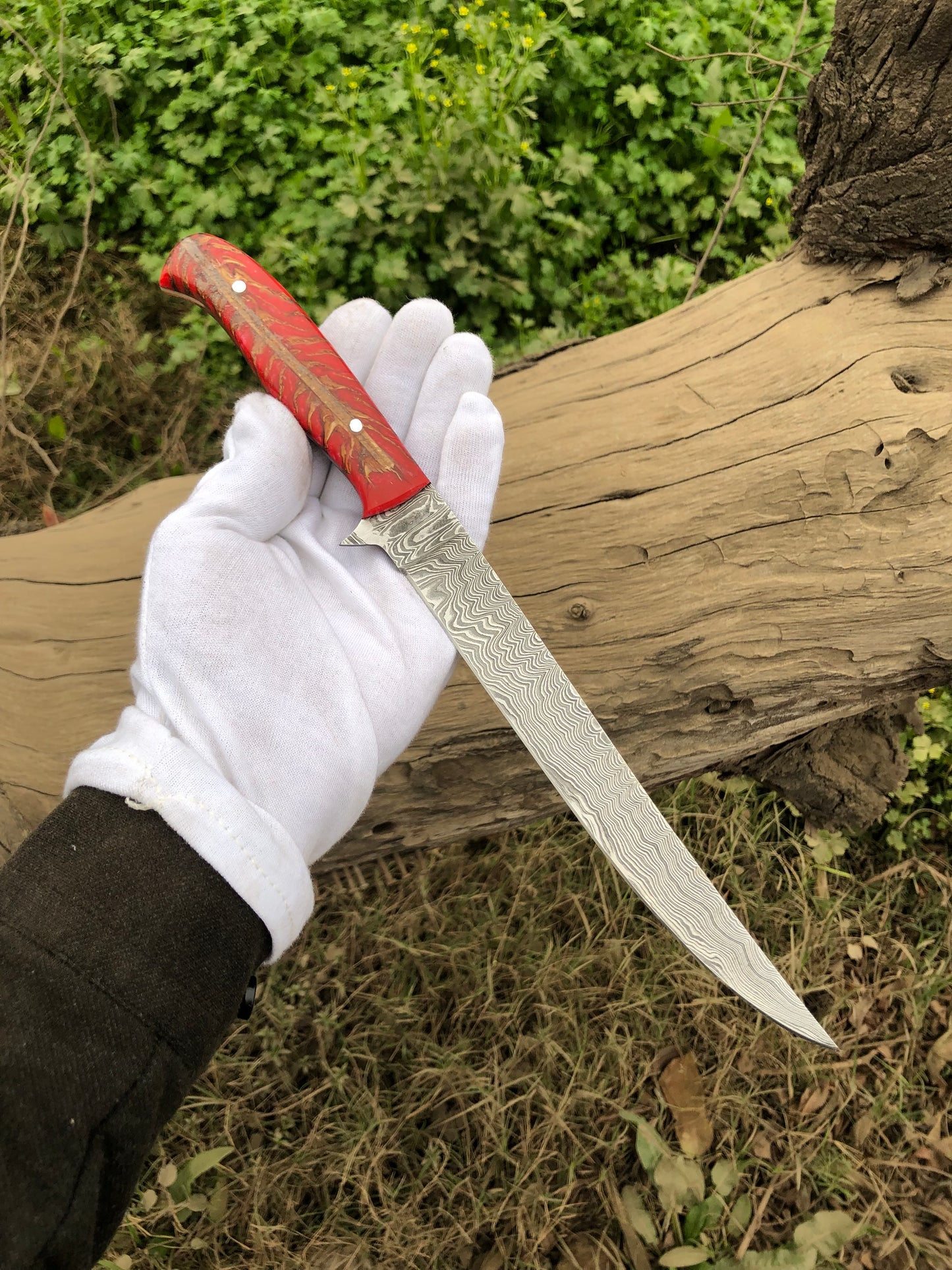 Damascus Steel Fillet Knife with a leather sheath, ideal for precise filleting
