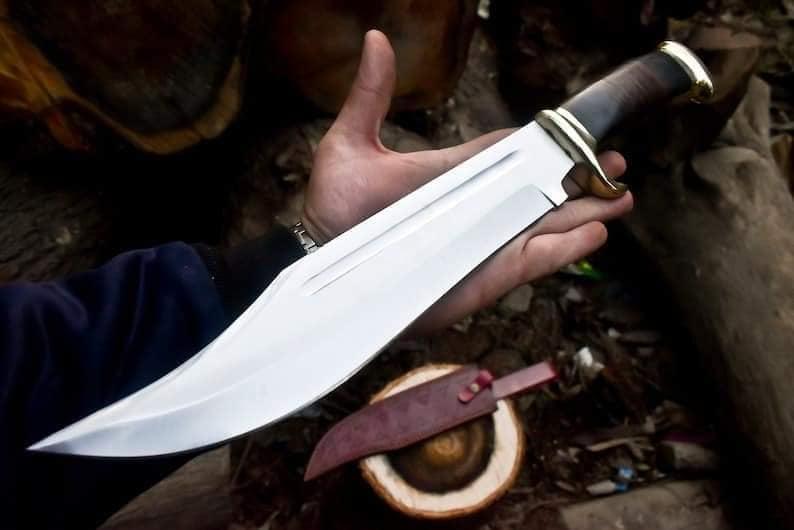 Crocodile Dundee Bowie Knife with brass guard and buffalo horn handle, featuring a leather sheath