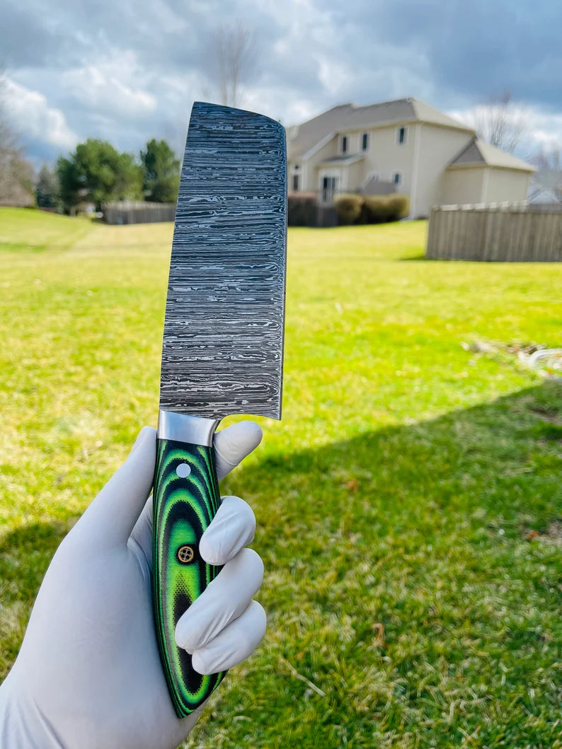 Full view of a 5-piece Damascus steel kitchen knife set with G10 handles, featuring steel bolsters