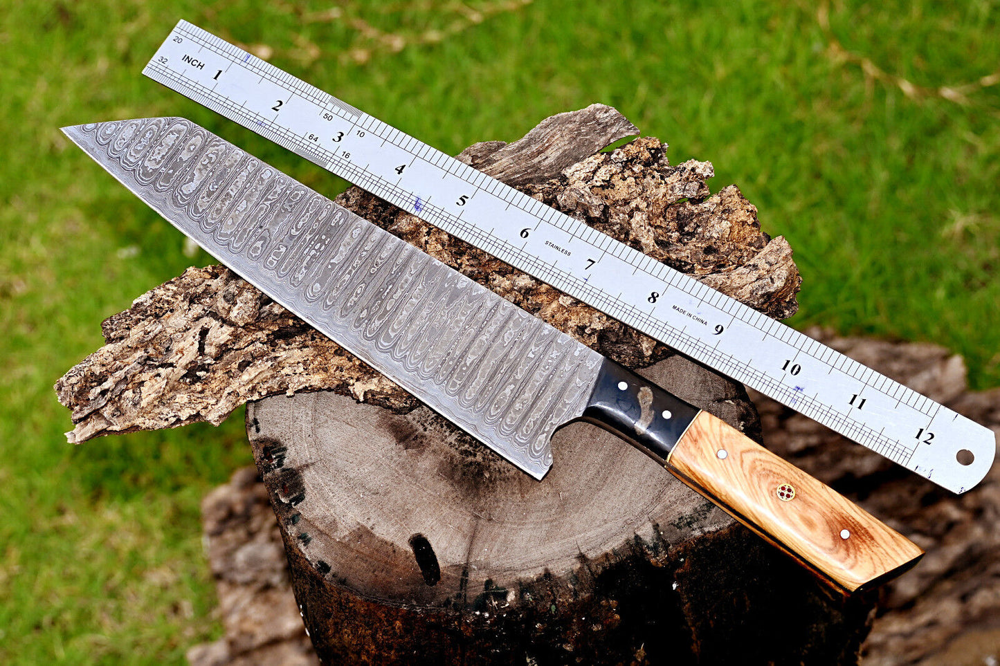 Hand-forged Damascus chef knife featuring a 7-inch blade and ergonomic olive wood and resin handle for precise and comfortable cutting