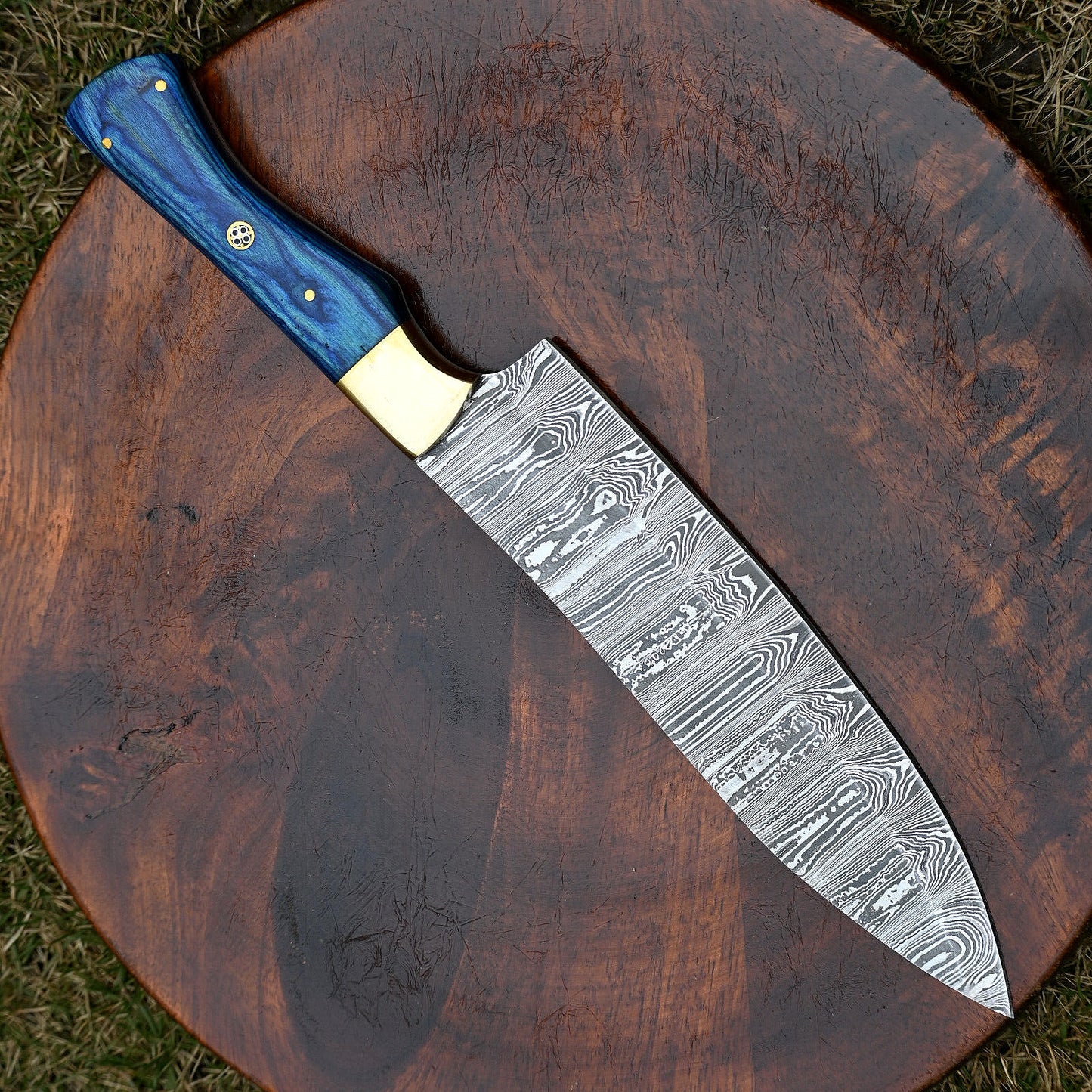 Hand-forged Damascus steel chef knife, 7-inch blade with pakkawood handle and brass bolster for balanced, comfortable grip.