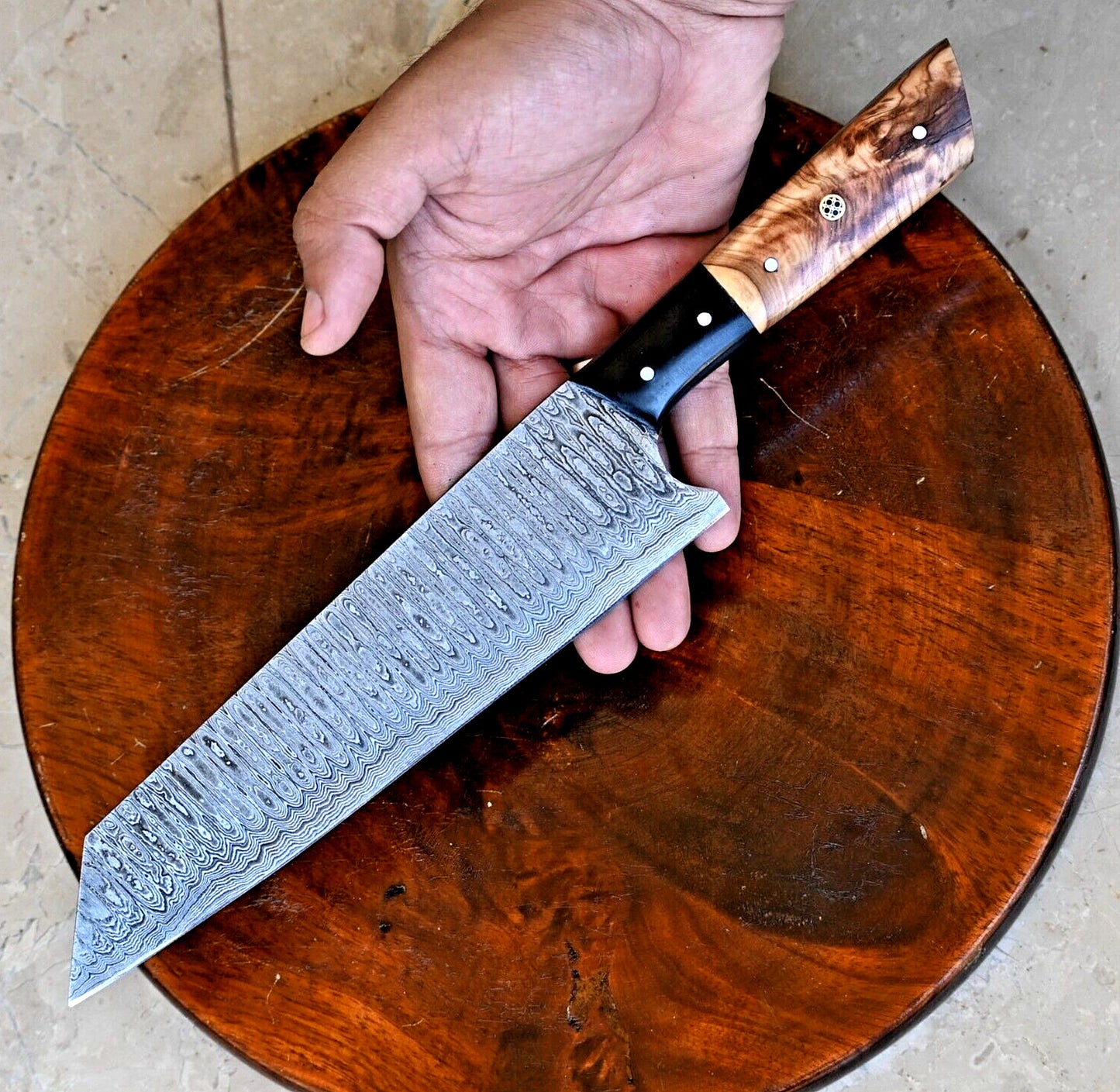 Hand-forged Damascus steel chef knife with 7-inch blade, ergonomic olive wood and resin handle for precision slicing and chopping