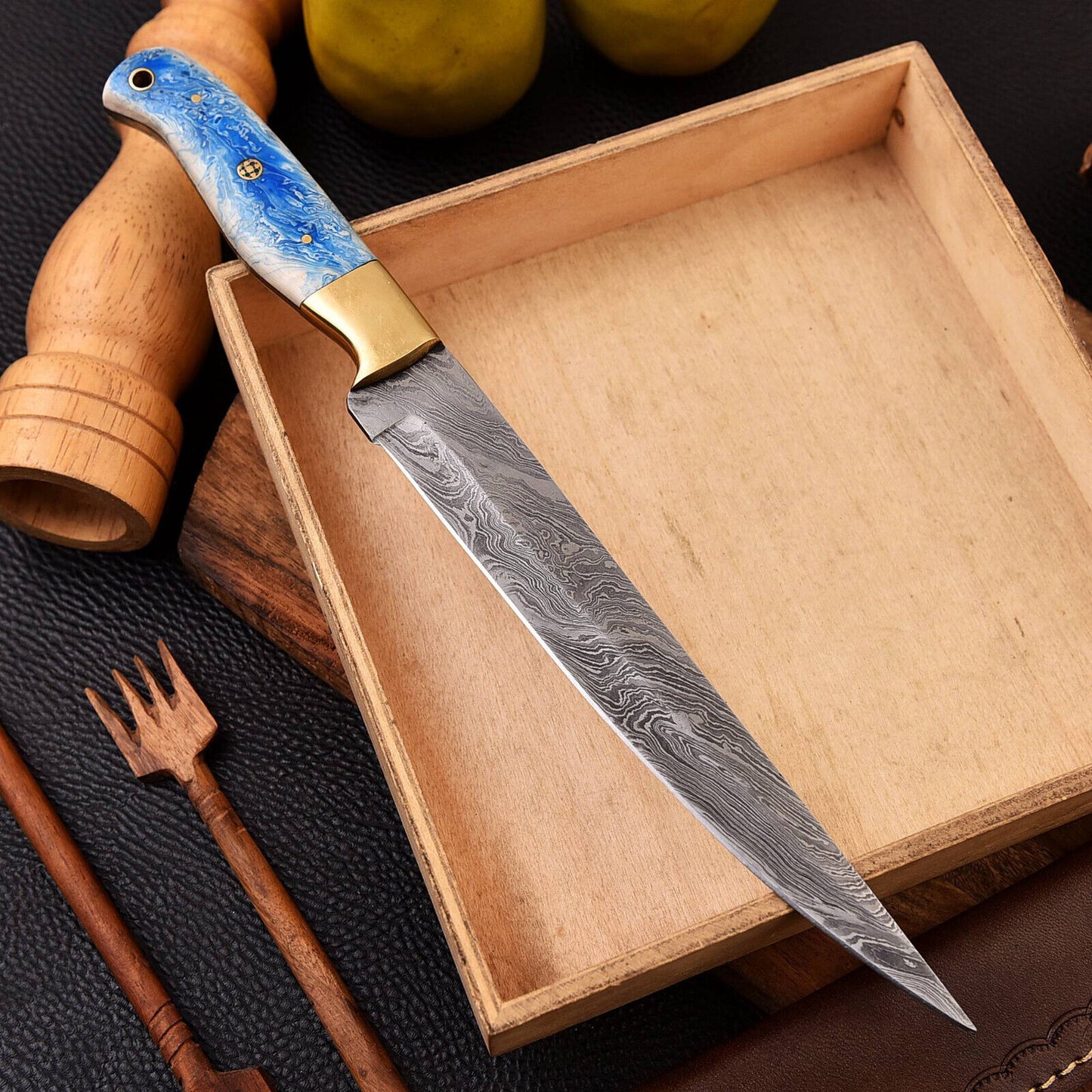 Handcrafted Damascus fillet knife with brass bolster and resin handle, including a leather sheath, ideal for precise filleting and as a gift item