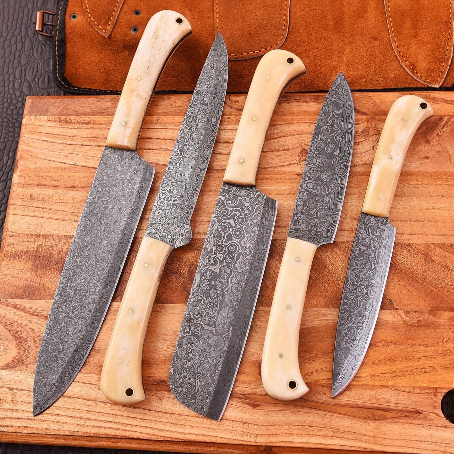 Handmade Damascus knife set featuring camel bone handles and blades ranging from 9 to 13 inches, perfect for chefs and collectors.