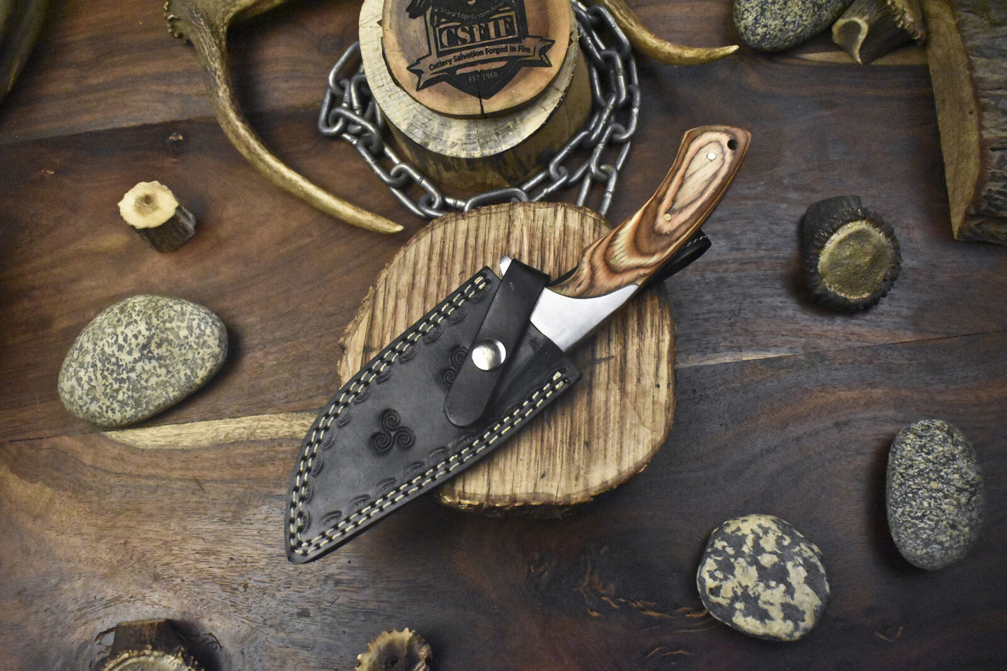 Handmade J2 steel hunting knife with a durable pakkawood handle and steel bolster, perfect for outdoor use.