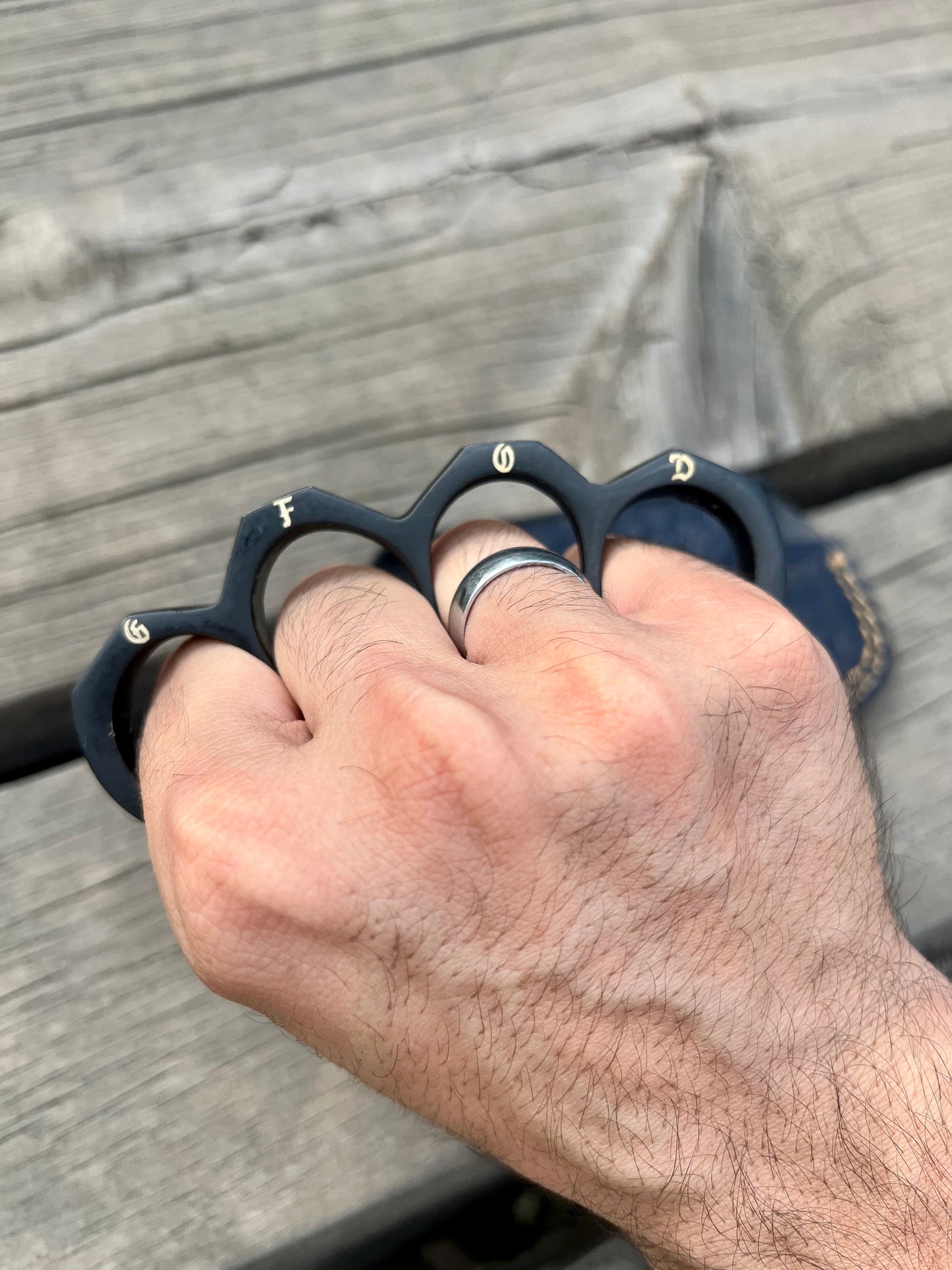 Matte black steel knuckle duster with personalized engraving option