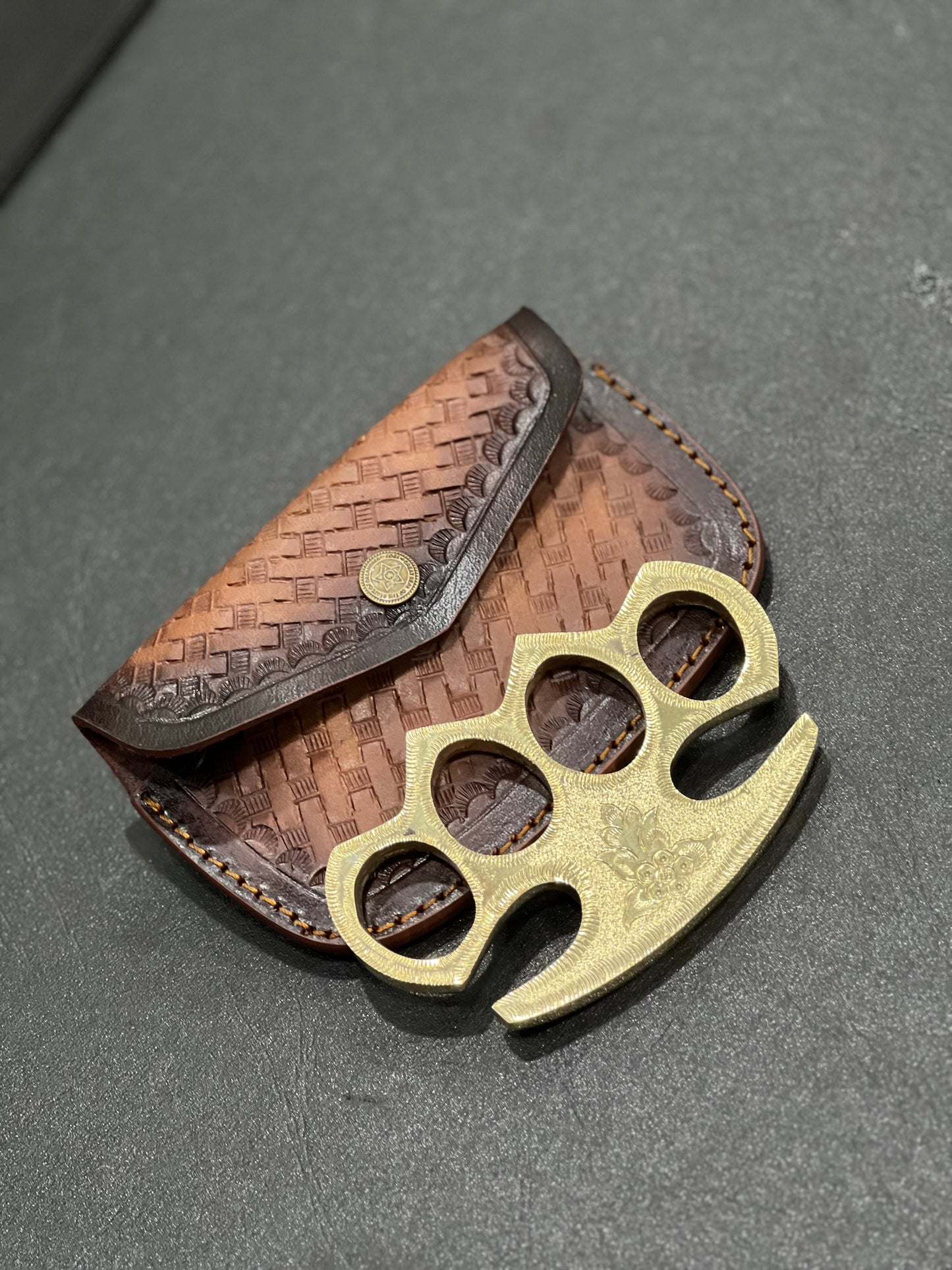 Person Wearing Engraved Brass Knuckles