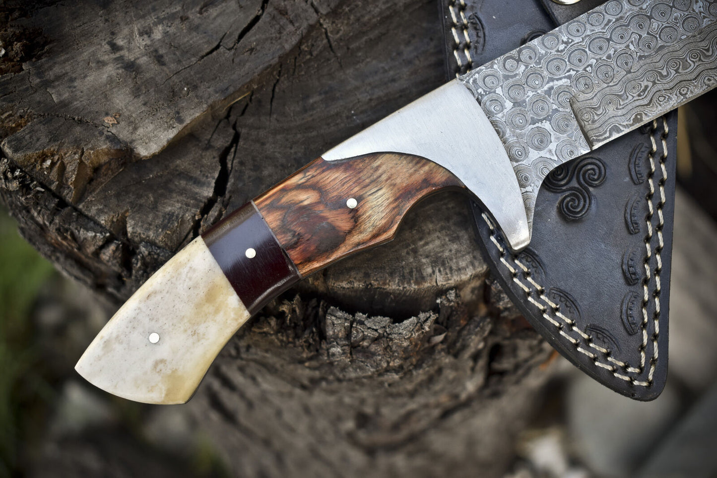 Premium Damascus steel hunting knife with pakkawood and camel bone handle, includes a leather sheath.