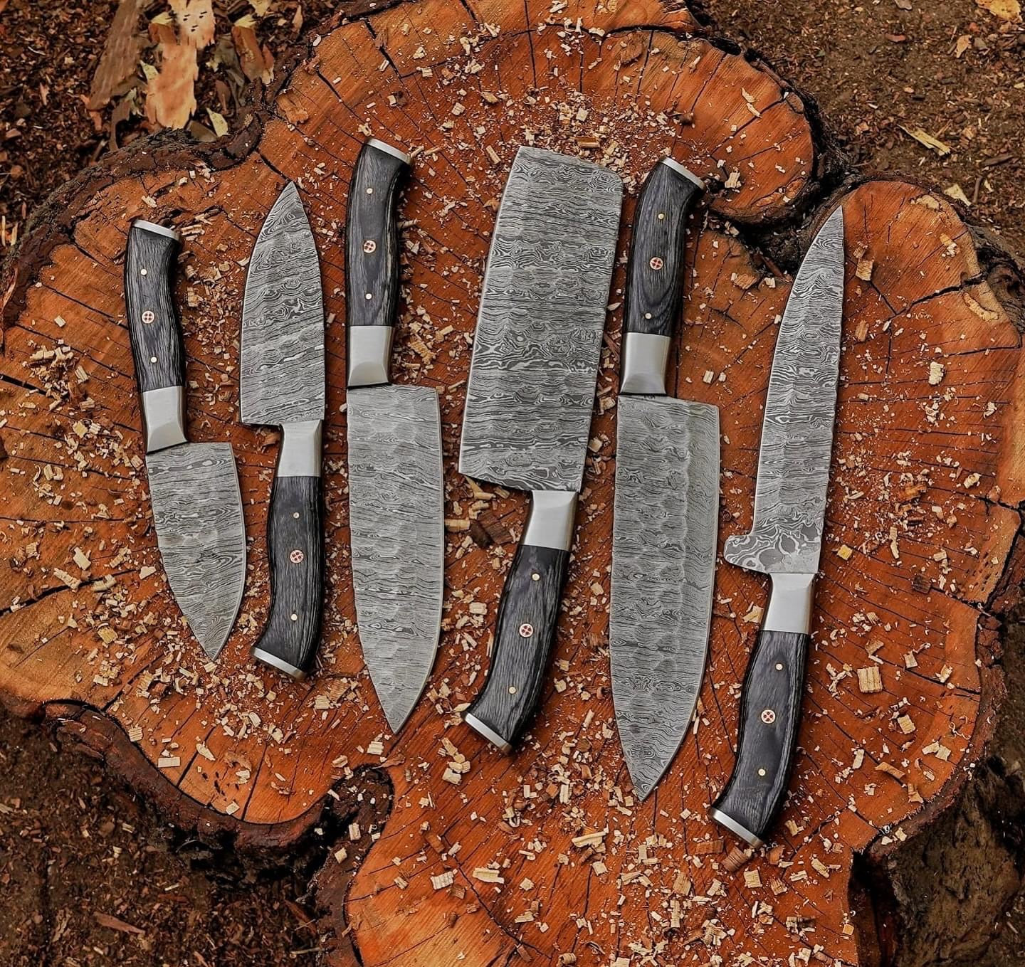 Set of custom handmade Damascus steel knives with hand-forged blades, pakkawood handles, and steel bolsters, perfect for culinary enthusiasts