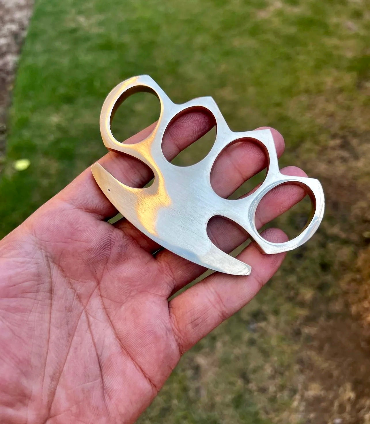 Solid brass knuckle with leather belt loop case, perfect for self-defense and everyday carry