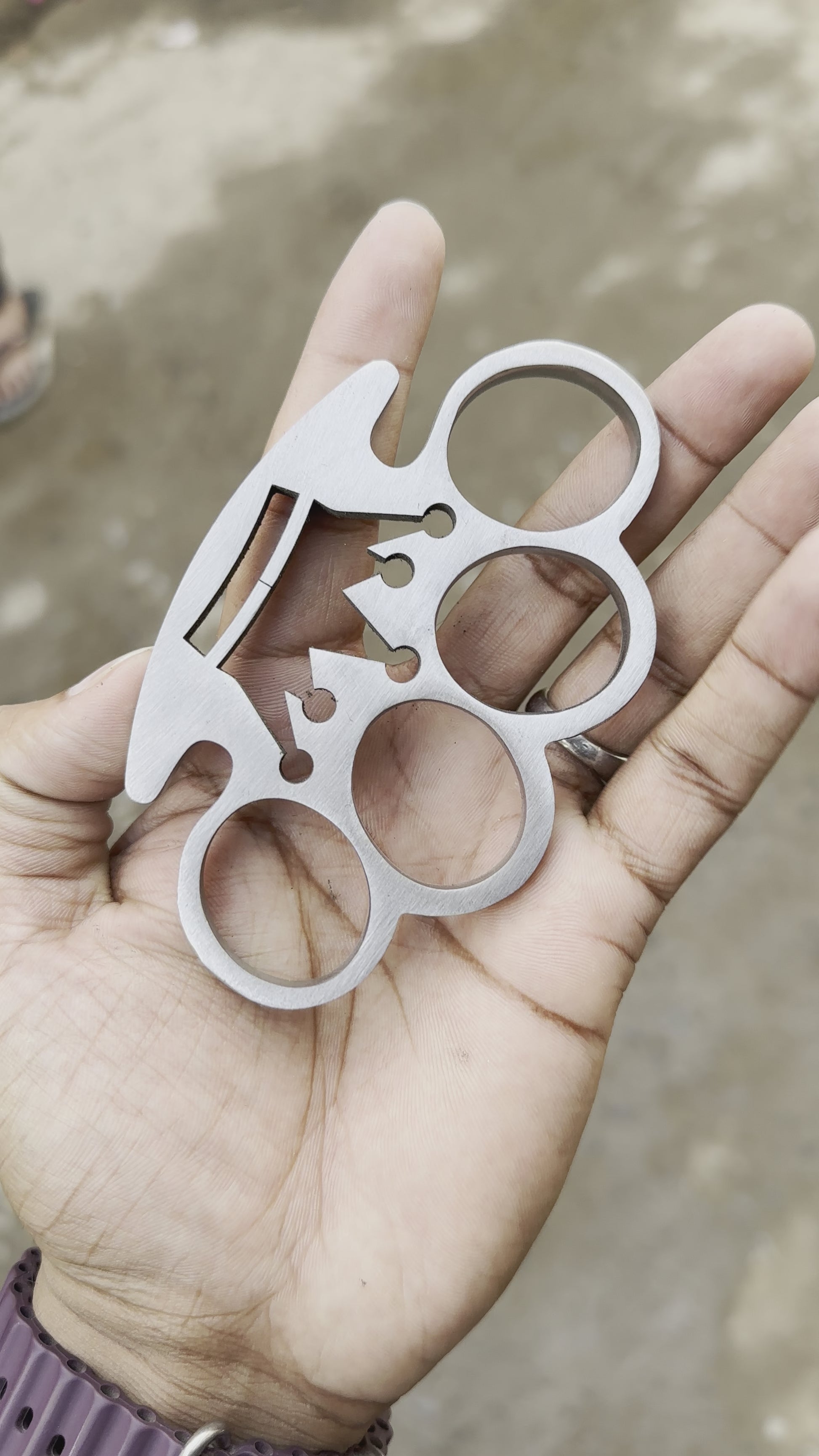 Front view of custom crown wirecut brass knuckle and leather case