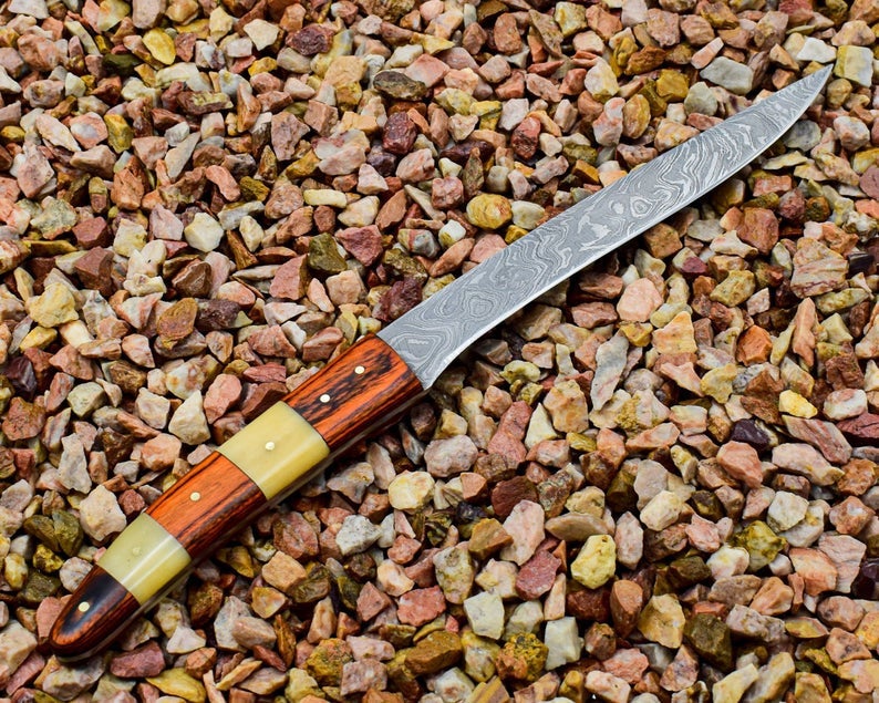 Close-up of the Damascus steel blade with bone and rosewood handle