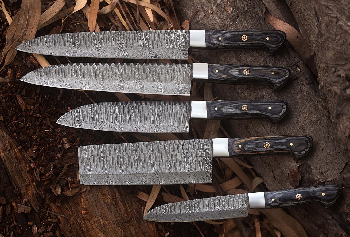 Full view of the Damascus kitchen knives set, showcasing exotic wood handles and steel bolsters, perfect as a gift item