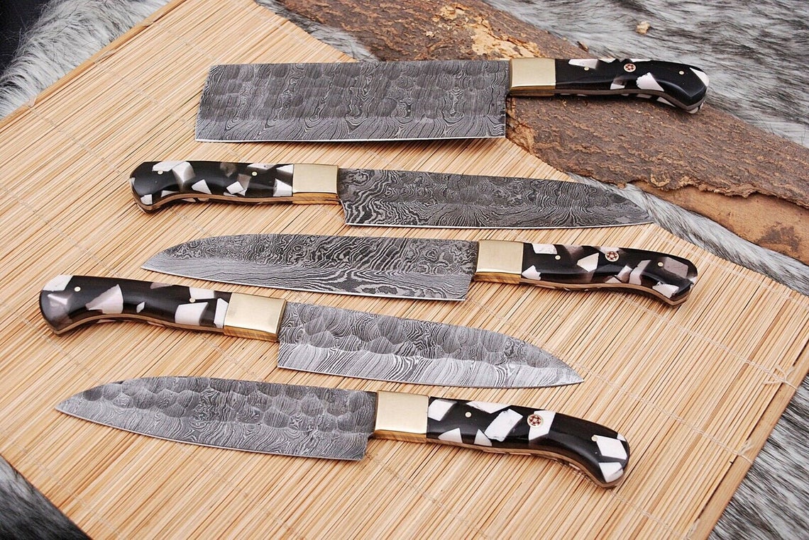 Luxurious Damascus kitchen knife set with exotic wood handles and custom twisted pattern blades, perfect for gourmet cooking