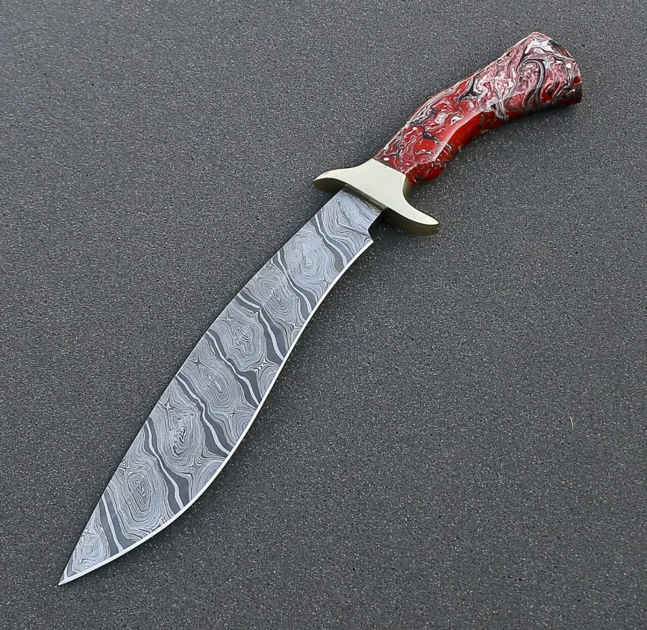 Custom handmade Damascus steel Bowie knife with a brass guard and resin handle, complete with a leather sheath.