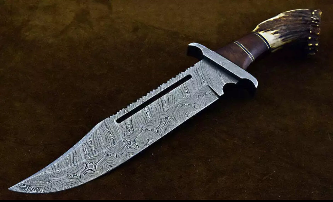 Custom handmade Damascus steel Bowie knife with Damascus steel guard, rosewood handle, and stag crown, complete with leather sheath.