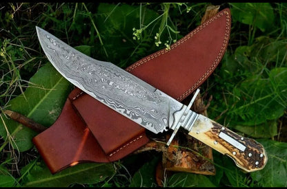 Custom handmade Damascus steel classic clip point Bowie knife with rosewood handle and leather sheath.