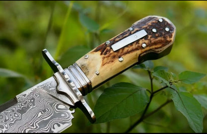 Custom handmade Damascus steel classic clip point Bowie knife with rosewood handle and leather sheath.