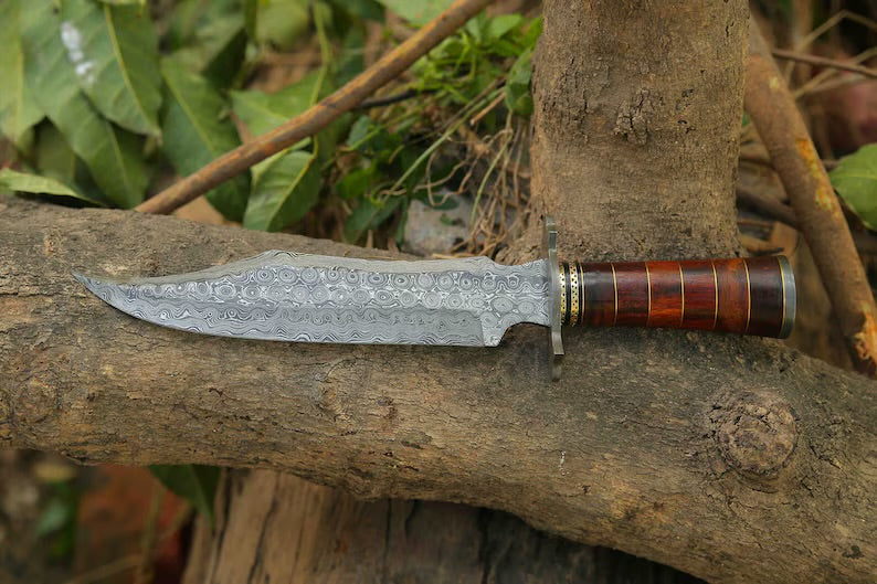 Custom handmade Damascus steel Bowie knife with a Damascus steel guard, rosewood, and brass handle, including a leather sheath.