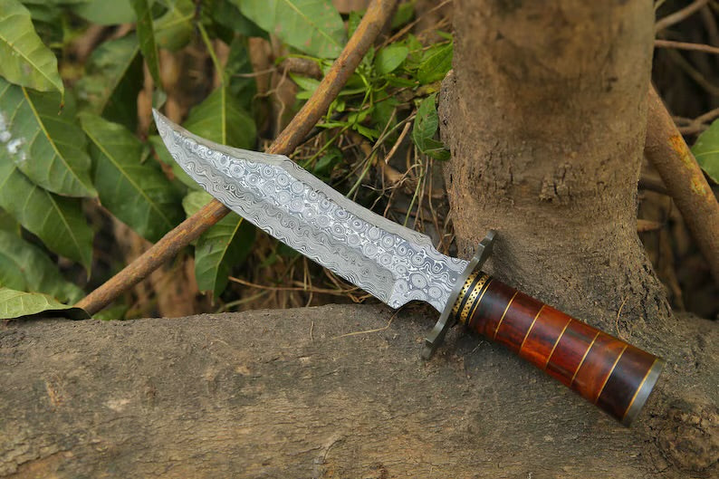 Custom handmade Damascus steel Bowie knife with a Damascus steel guard, rosewood, and brass handle, including a leather sheath.