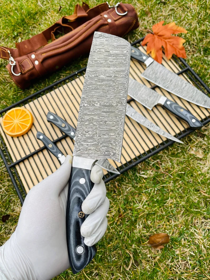 	Close-up of Damascus steel blade with G10 handle from a professional 5-piece kitchen knife set