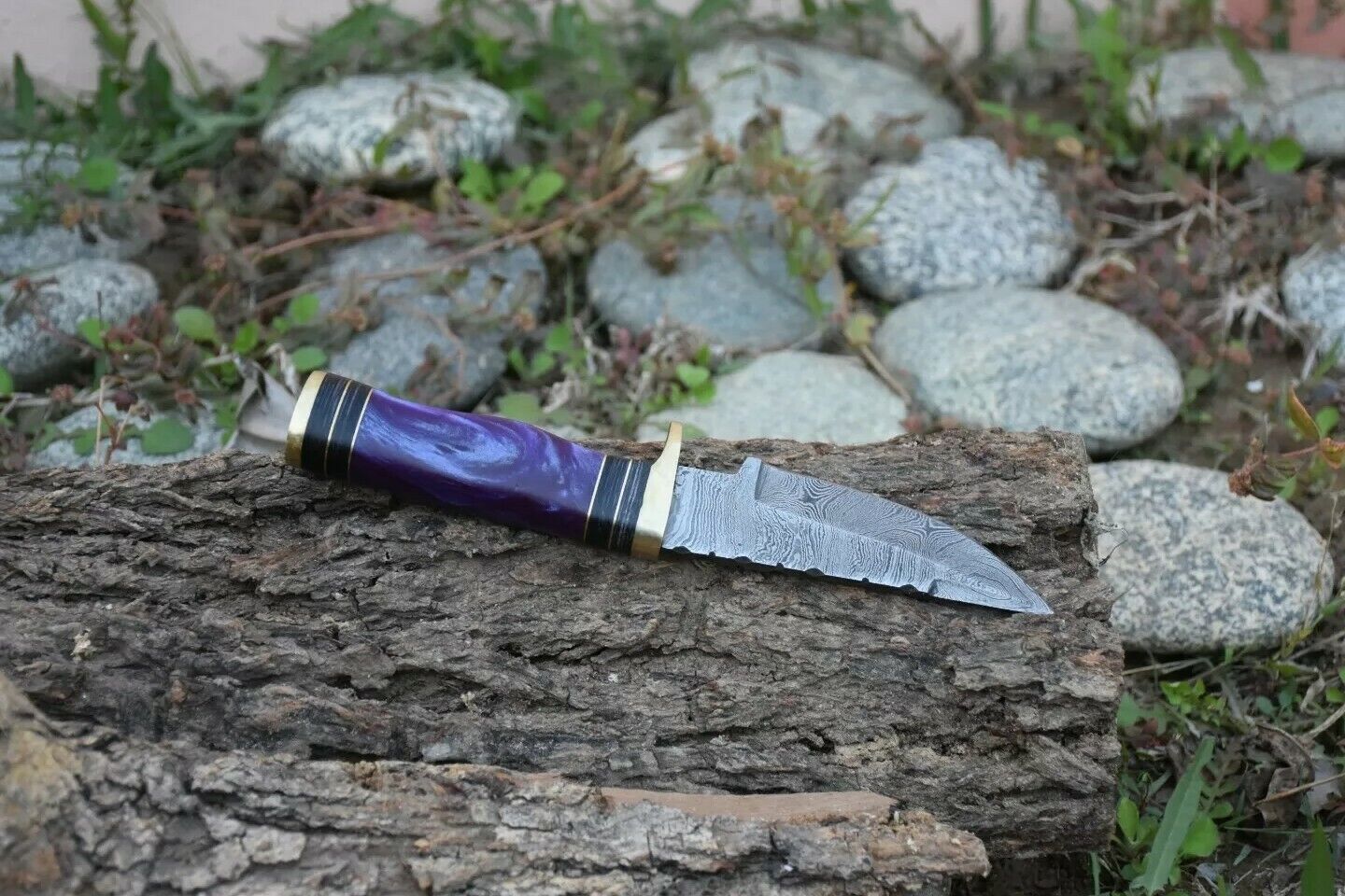 Close-up of the Damascus steel blade on an 8-inch hunting knife with intricate patterns
