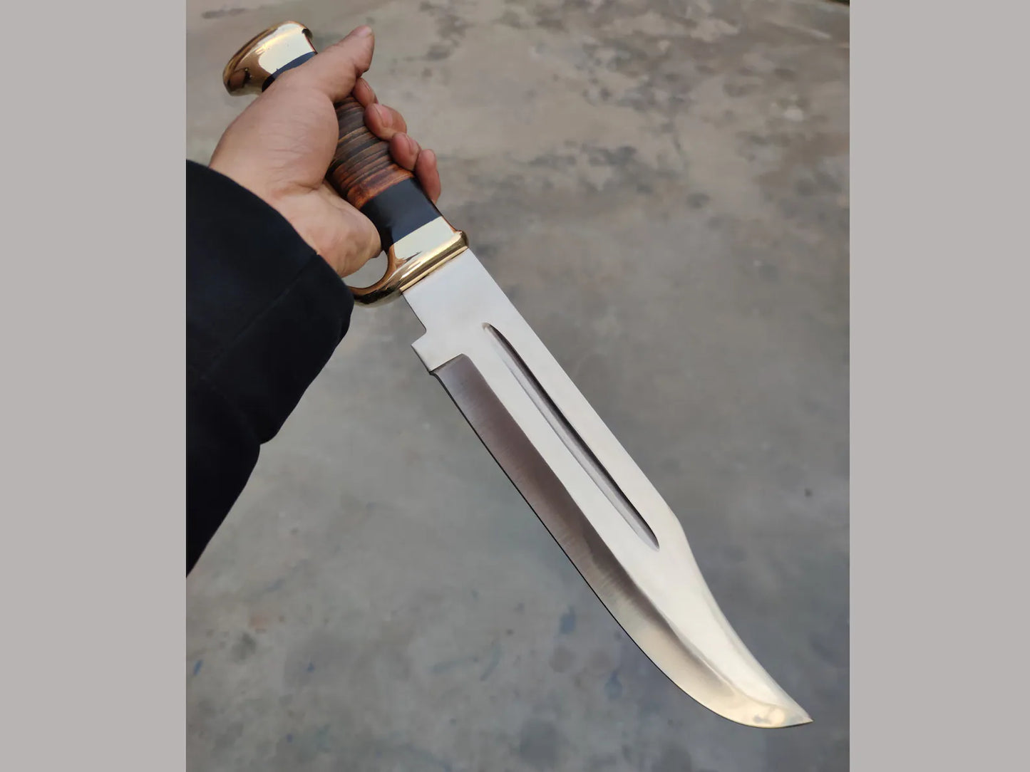 "Crocodile Dundee Bowie Knife by Paul Hogan featuring a 16-inch 440C steel blade, leather and buffalo horn handle, brass guard, and beautiful leather sheath.