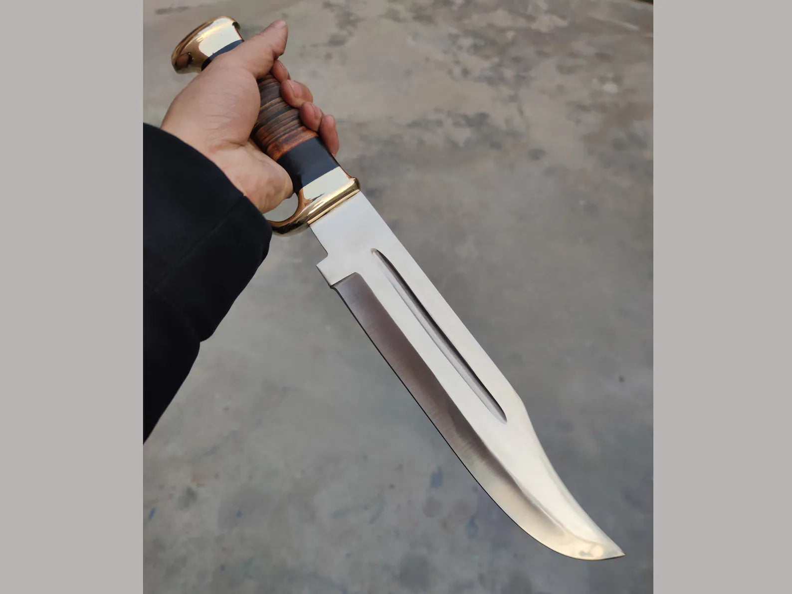 "Crocodile Dundee Bowie Knife by Paul Hogan featuring a 16-inch 440C steel blade, leather and buffalo horn handle, brass guard, and beautiful leather sheath.