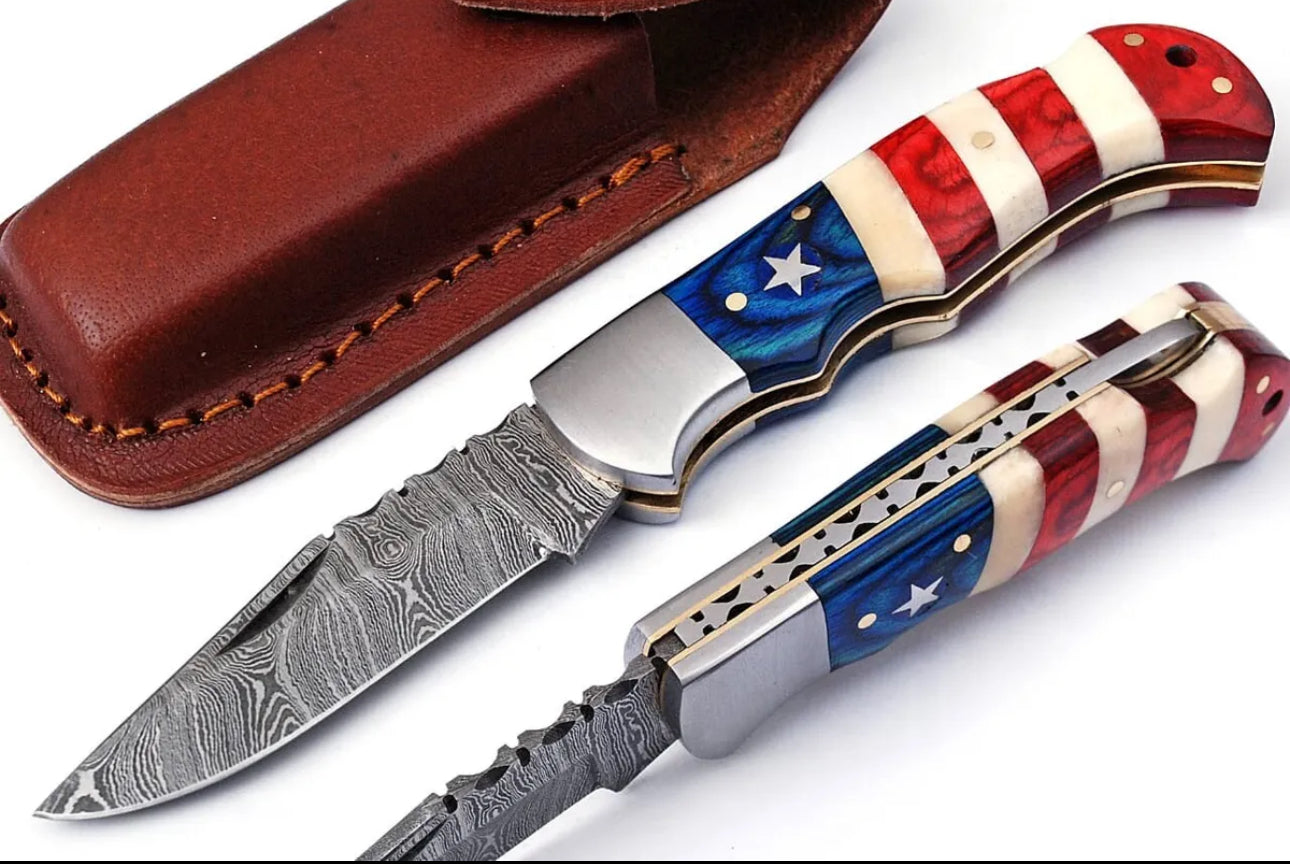 Custom Handmade Damascus folding knife with a 3-inch blade and American Flag handle, featuring a steel bolster and leather sheath