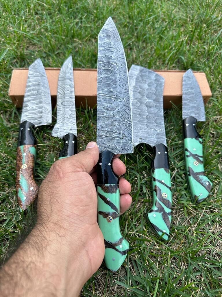 Custom handmade Damascus steel kitchen knife set featuring ergonomic resin handles and blades ranging from 9 to 13 inches