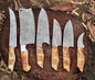 Custom handmade Damascus steel knives set with 3 to 8-inch hand-forged blades and camel bone handles, showcasing unique wave patterns and artisan craftsmanship