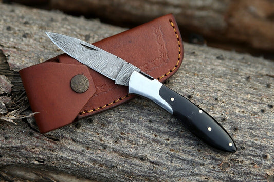 Custom handmade Damascus steel pocket knife with buffalo horn handle and steel bolster"
