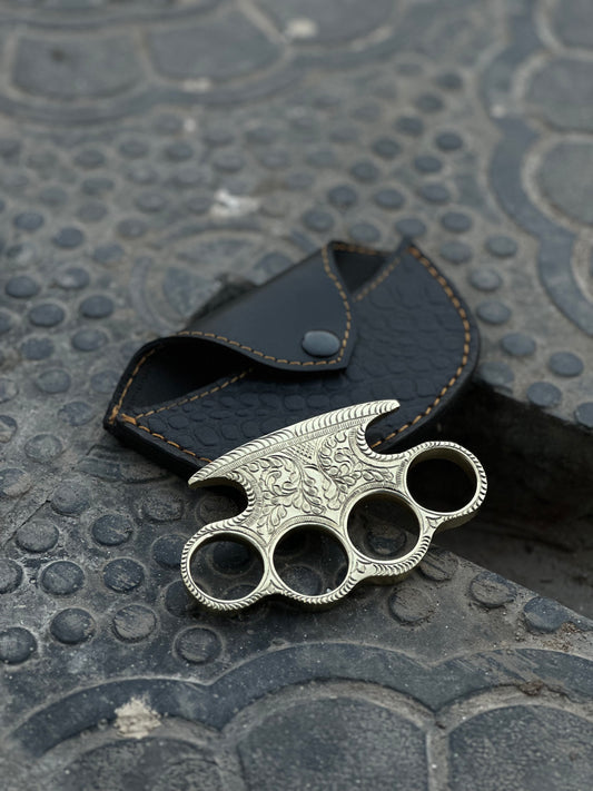 "Custom handmade engraved brass knuckles made from pure brass with intricate designs."
