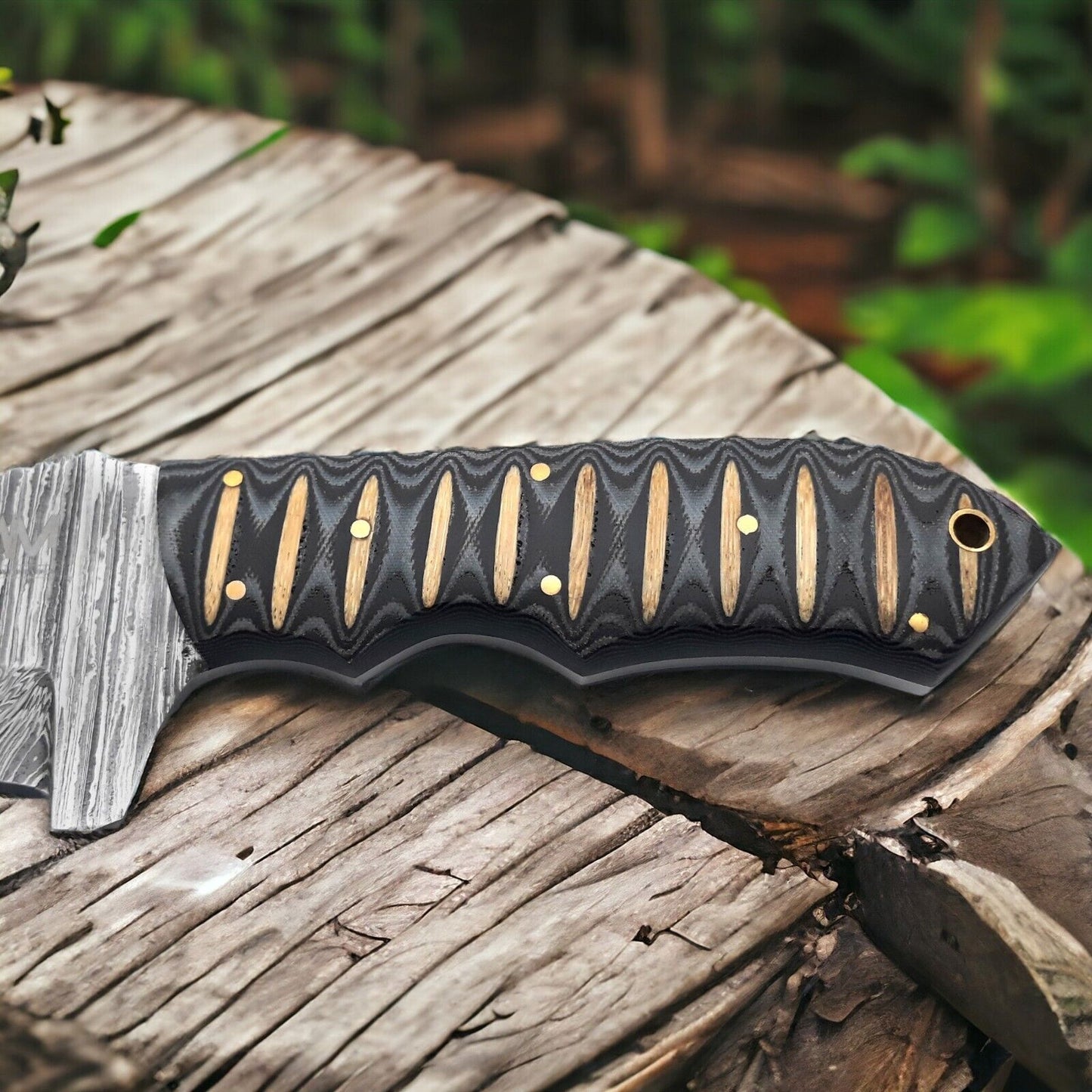 Damascus steel Tom Brown tracker knife featuring intricate blade patterns and leather sheath.