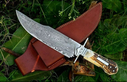 Custom handmade Damascus steel classic clip point Bowie knife with rosewood handle and leather sheath.