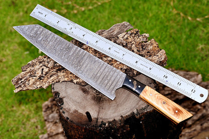 Hand-forged Damascus chef knife featuring a 7-inch blade and ergonomic olive wood and resin handle for precise and comfortable cutting